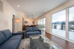The Tree Haus living room features cozy seating and incredible views of Whitefish Lake.